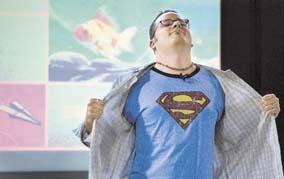 Cartoonist Jason Kotecki reveals his Superman within during a talk Sunday at St. Anthonys Church in Portsmouth. He recalled how having a Superman T-shirt made him think as a boy that he really was the comic-book hero. Jason Kotecki is Superman. (Megan Rathfon/Daily News staff)